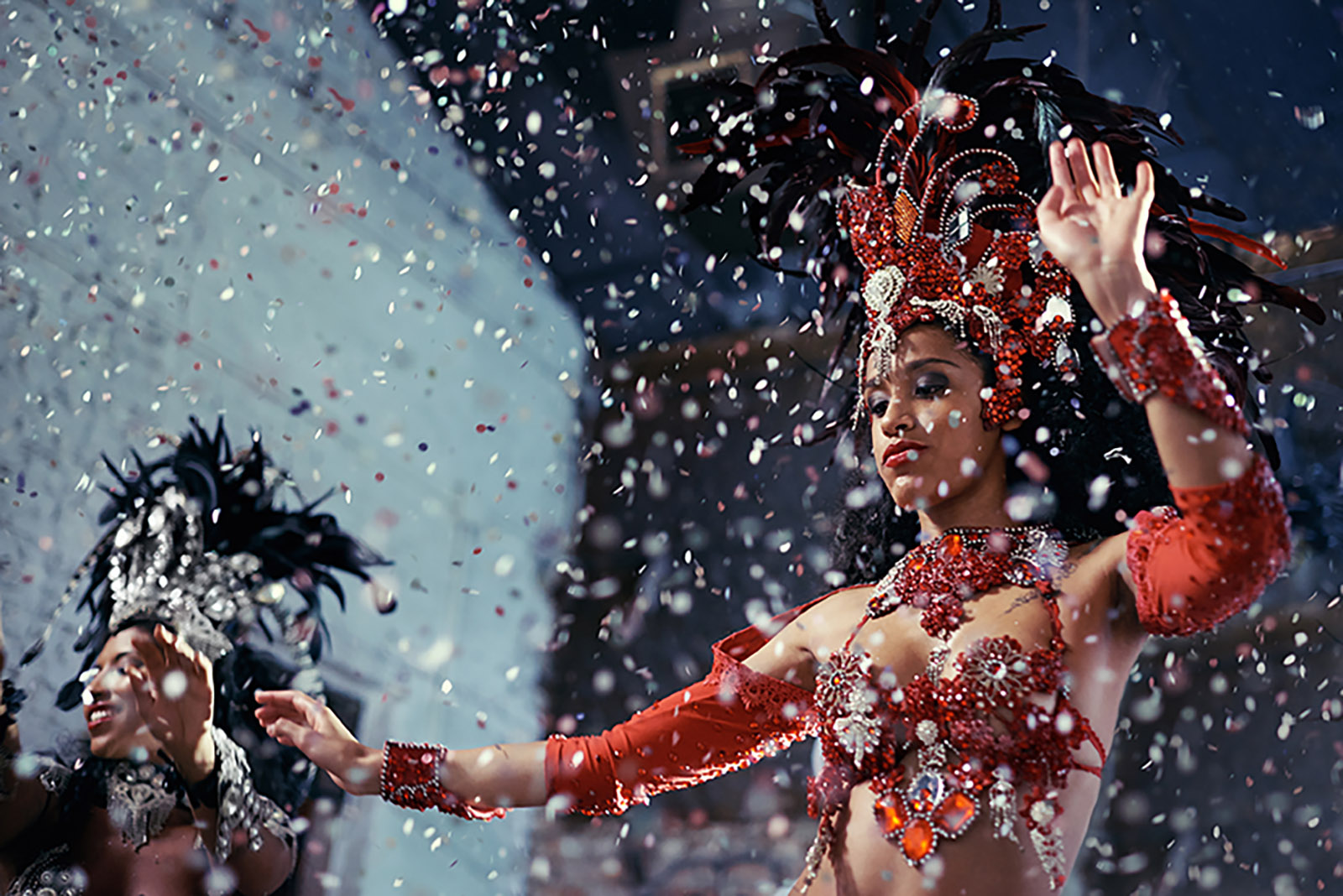 Shot of two beautiful samba dancers performing in a carnival.