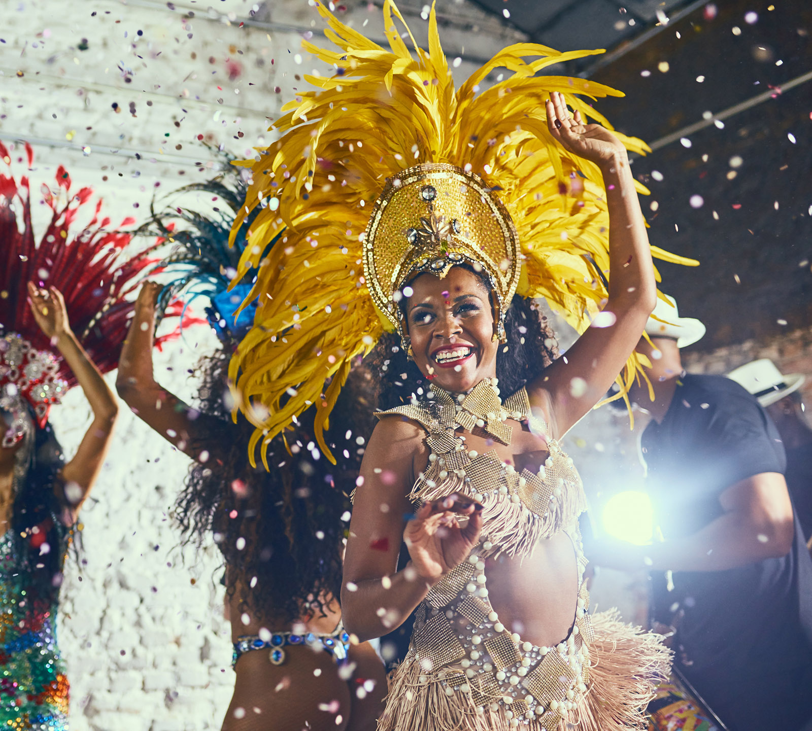 Cropped shot of beautiful samba dancers performing in a carnival with their band.